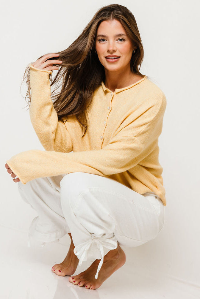 Model in the Piper button-front knit cardigan in honey