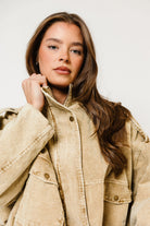 Model in the Saint washed corduroy boyfriend jacket in sandy beige with a collar and snap front